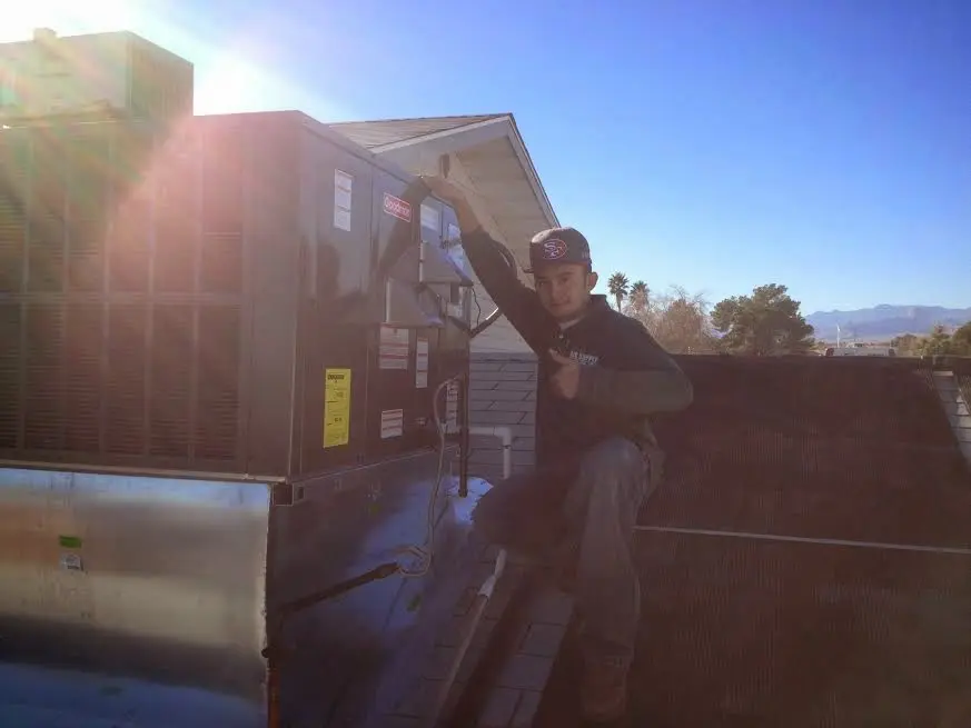 HVAC technician performing HVAC Inspection on a rooftop unit in Lampasas